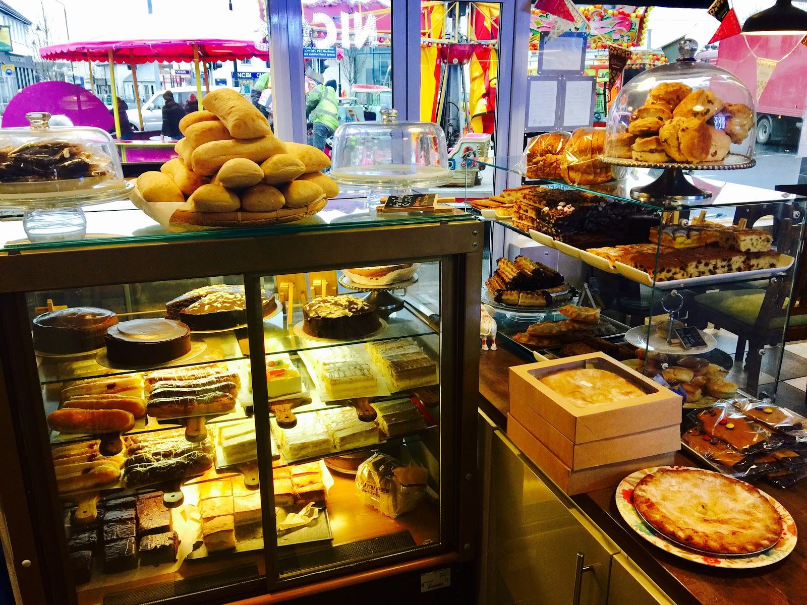 The bakery counter at Nico's, stacked with cakes, eclairs, brownies, scones and fresh bread rolls