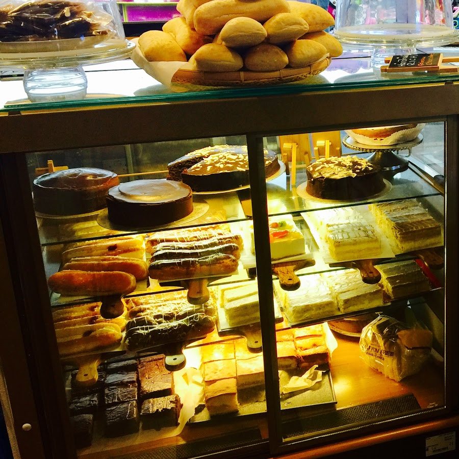 Cakes, eclairs and brownies in the bakery counter at Nico's