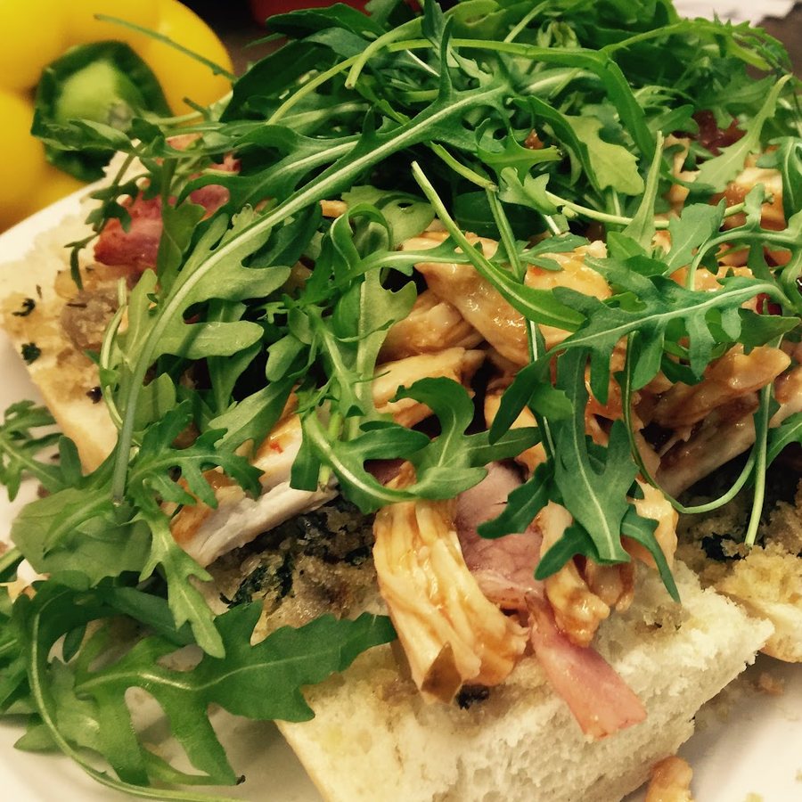 An open sandwich with chicken, ham, stuffing and rocket at Nico's